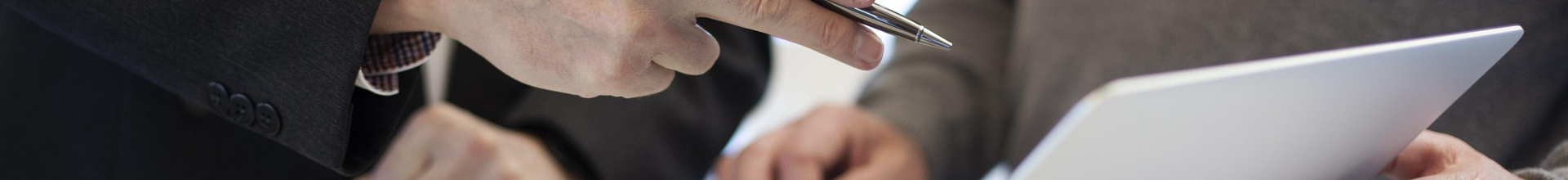 Business men pointing out to laptop in a business meeting for BPO at AL Zahronix Consulting office